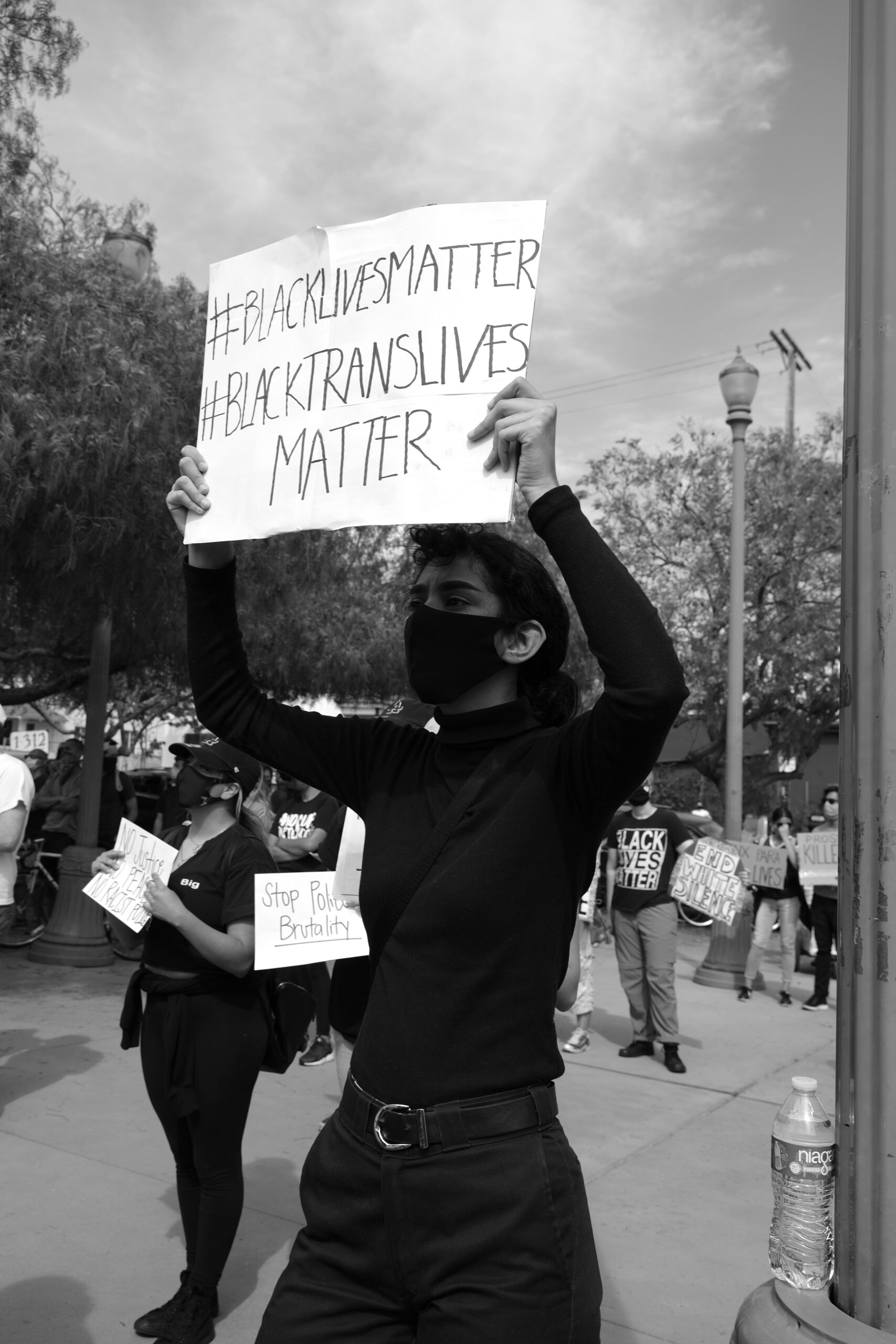 grayscale photo of person holding white and black printed paper